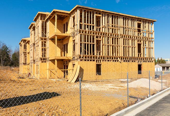 a job site enclosed by temporary chain link fences, ensuring safety for workers and pedestrians in Downey